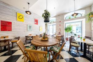 a restaurant with a wooden table and chairs at We Love F Tourists in Lisbon