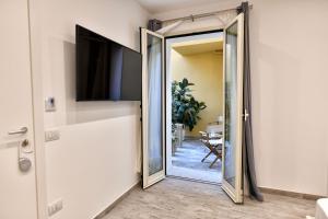 a door leading into a living room with a mirror at VL Central Room in Olbia