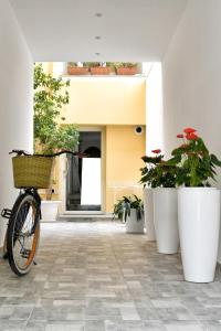 a bike parked in a hallway with potted plants at VL Central Room in Olbia