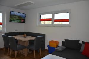a living room with a table and a couch at Appartement Wieshof in Neukirchen am Großvenediger
