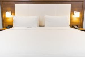 a large white bed with two pillows in a room at Holiday Inn Express Hollywood Walk of Fame by IHG in Los Angeles