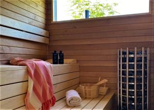 una sauna con ventana y botellas de vino en Dunazug Plusz Luxus Apartman, en Dömös