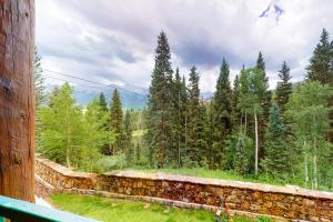 a view of a forest from a stone wall at Mountain Lodge in Telluride