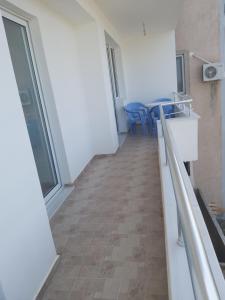 a hallway of a building with a table and chairs at Seafront apartment in Ksamil