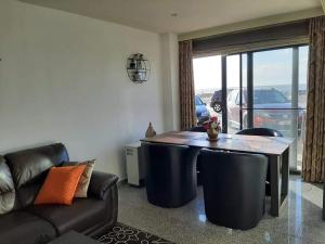 a living room with a table and a couch at Appartement "Zeezicht 002" in Ostend