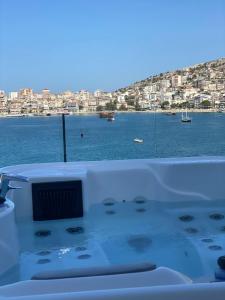 a bath tub with a view of the water at Demi Hotel in Sarandë