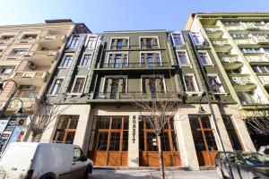 a building with a van parked in front of it at Hotel Cara 28 in Skopje