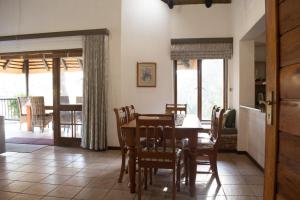 a kitchen and dining room with a table and chairs at Kruger Park Lodge Unit 245 in Hazyview