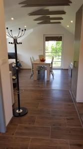 a dining room with a wooden floor and a table at Apartma Cifra Begunje in Begunje na Gorenjskem +2 photos