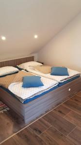 two large beds in a room with wooden floors at Apartma Cifra Begunje in Begunje na Gorenjskem