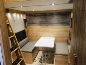 a small room with a white table and benches at Chapel Fields Holiday Park in Chapel Saint Leonards