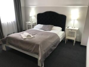 Łóżko lub łóżka w pokoju w obiekcie Rezydencja Sandomierska