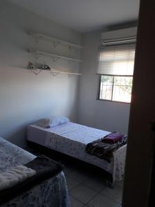 a bedroom with two beds and a window at no centro de Cuiabá aptº mobiliado in Cuiabá
