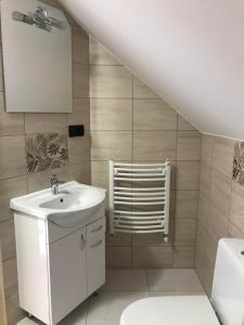 a bathroom with a white sink and a staircase at Apartament u Beaty i Heńka, Łapszanka in Łapszanka