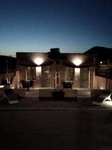 a small house at night with lights on it at Villa Mare Angelica in Perivolos