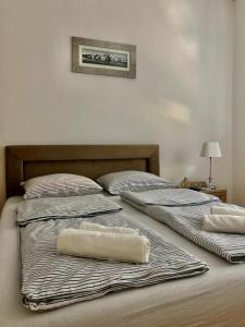 two beds with towels on them in a bedroom at Apartment Bregovi in Trebinje