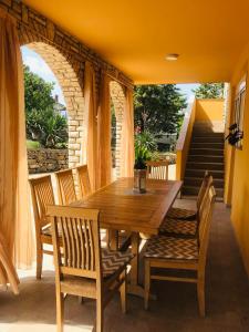 a wooden table and chairs on a patio at Holiday house with heated pool Vugica in Polje