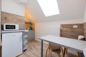 a small kitchen with a table and a microwave at Pri Marusi in Kranjska Gora