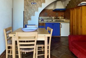 a kitchen with a table and chairs in a room at Vivi Marettimo in Marettimo