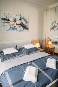 a bedroom with a blue bed with two pillows at Apartament 15 in Kościerzyna