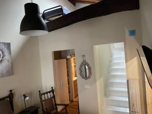 a hallway with a staircase and a light fixture at LA CASINA DE PAULA in Ríoseco