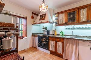 a kitchen with wooden cabinets and a sink at Caserio Urikosolo in Bilbao