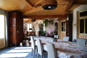a dining room with a large table and chairs at La Valinière in Seur