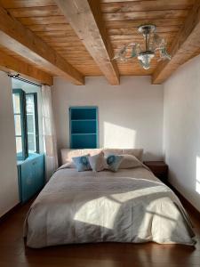 a bedroom with a large bed with a wooden ceiling at Entre Ciel et Mer in Bonifacio