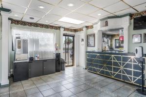 a large kitchen with a blue counter top at Knights Inn Trevose in Trevose