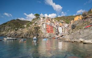a view of a city with boats in the water at Casa Elisa in Riomaggiore