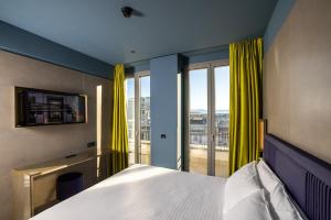 a bedroom with a bed and a large window at HD8 Hotel Milano in Milan