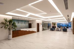 an office lobby with a potted plant in the middle at Best Western Plus Riviera Veracruz in Veracruz