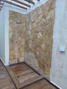 a stone shower in a room with a stone wall at Rede Suítes in Maragogi +71 photos