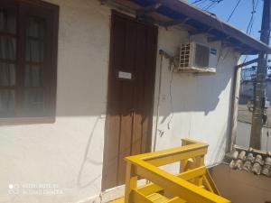 a yellow chair sitting in front of a building at Hospedagem dona Alaide in Paraty