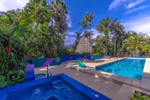 a pool at a resort with palm trees at Xandari Resort & Spa in Alajuela