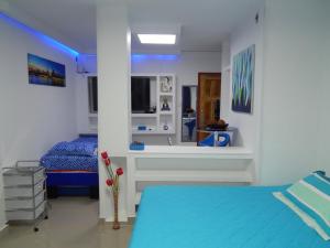 a bedroom with a bed and a sink and a mirror at Delfin 207 in Cartagena de Indias +8 photos
