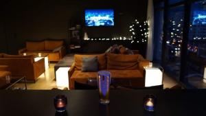 a living room filled with furniture and lights at Galaxy Pod Hostel in Reykjavík