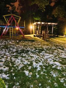 a park at night with a playground and a slide at Residencial Pousada do Serrano in Gramado