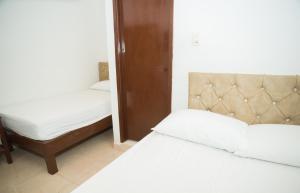 Postel nebo postele na pokoji v ubytování Hotel Clau