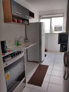 a kitchen with a refrigerator and a stove in it at Apto Oniz Campos X in Campos dos Goytacazes