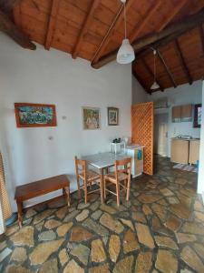 a kitchen with a table and chairs in a room at Beautiful house located on a hill, with a spectacular sea view in Koumeika