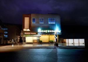 a building with a sign on the side of it at night at Hotel BV Colours Bommanahalli in Bangalore +23 photos
