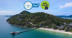 an island in the water with a pier and two stickers at Santhiya Koh Yao Yai Resort & Spa in Ko Yao Yai