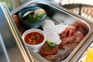 a tray of food with meat and other foods at Cassowary Falls Gateway Daintree in Daintree