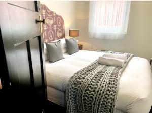 Un dormitorio con una gran cama blanca y una ventana en The Barkly Bistro Bar & Accommodation en Ararat