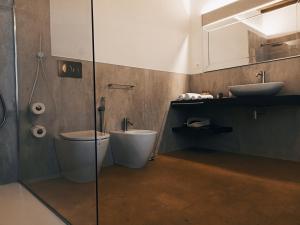 a bathroom with a toilet and a sink at La Corte Dei Sogni B&B in Modena