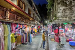 a boy walking through a market in a street at Hotel Ibex in Manāli