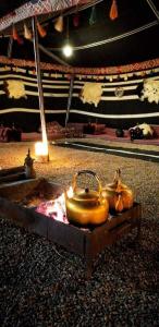 a group of three tea pots on a table at Wadi Rum Dream Camp in Wadi Rum