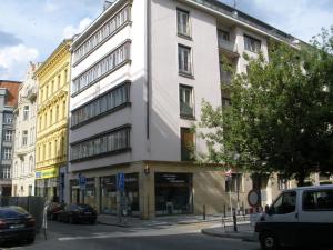 a white building on the corner of a street at Apartments Tronicek in Prague