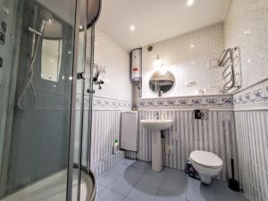 a bathroom with a shower and a toilet and a sink at Golosievo residence 60m2 in Kyiv